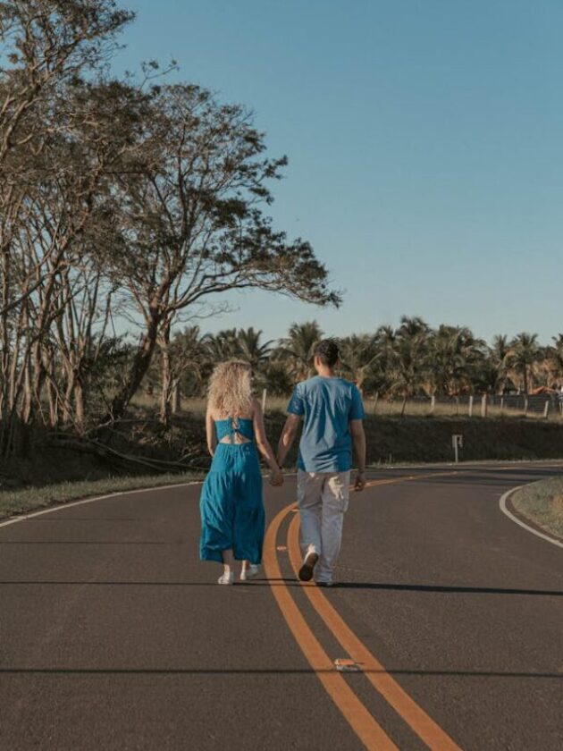 free-photo-of-man-and-woman-walking-along-road-holding-hands